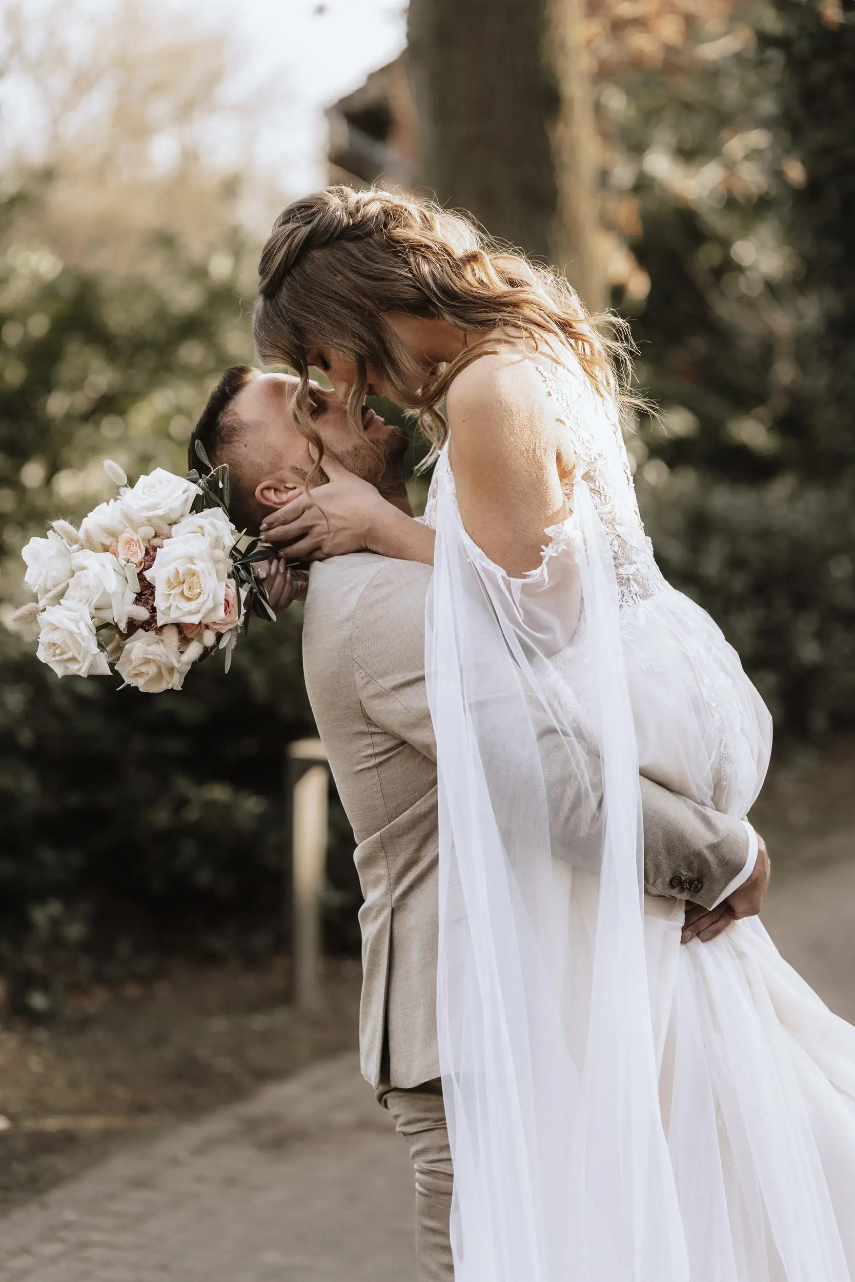Man and woman hugging in wedding clothes
