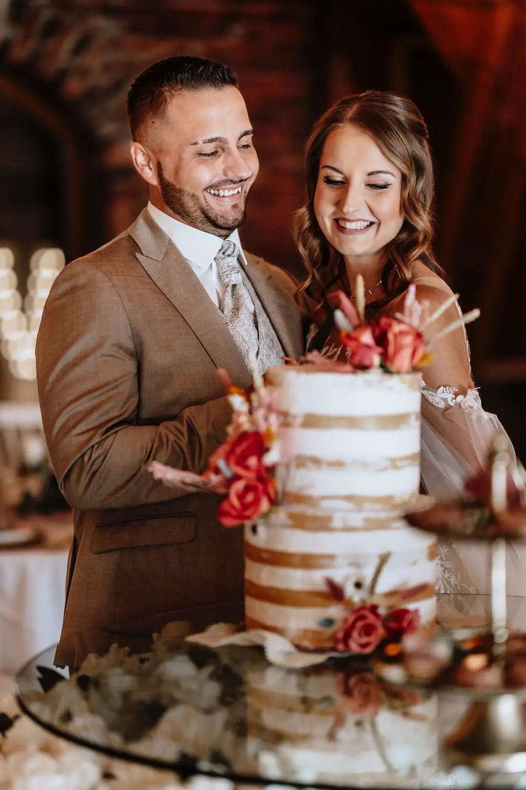 Man and woman in wedding clothes cutting wedding cake