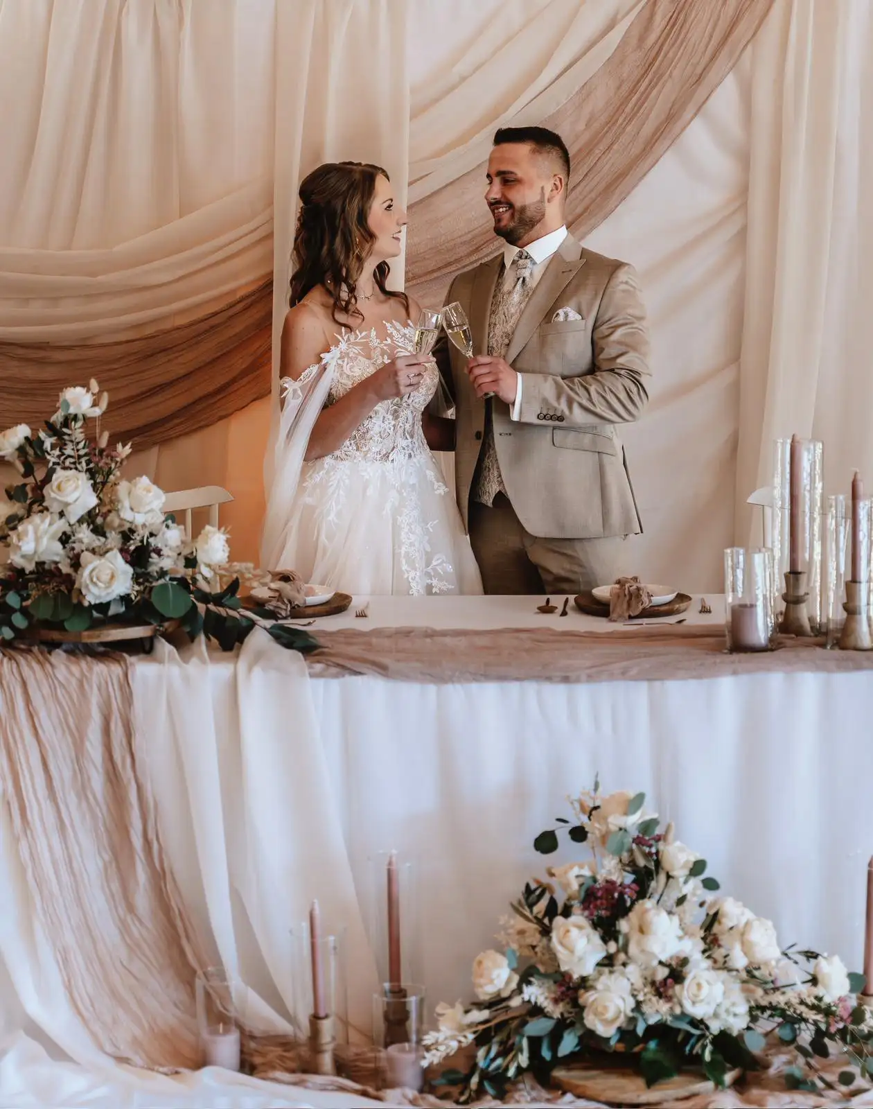 Man and woman in wedding clothes drinking together