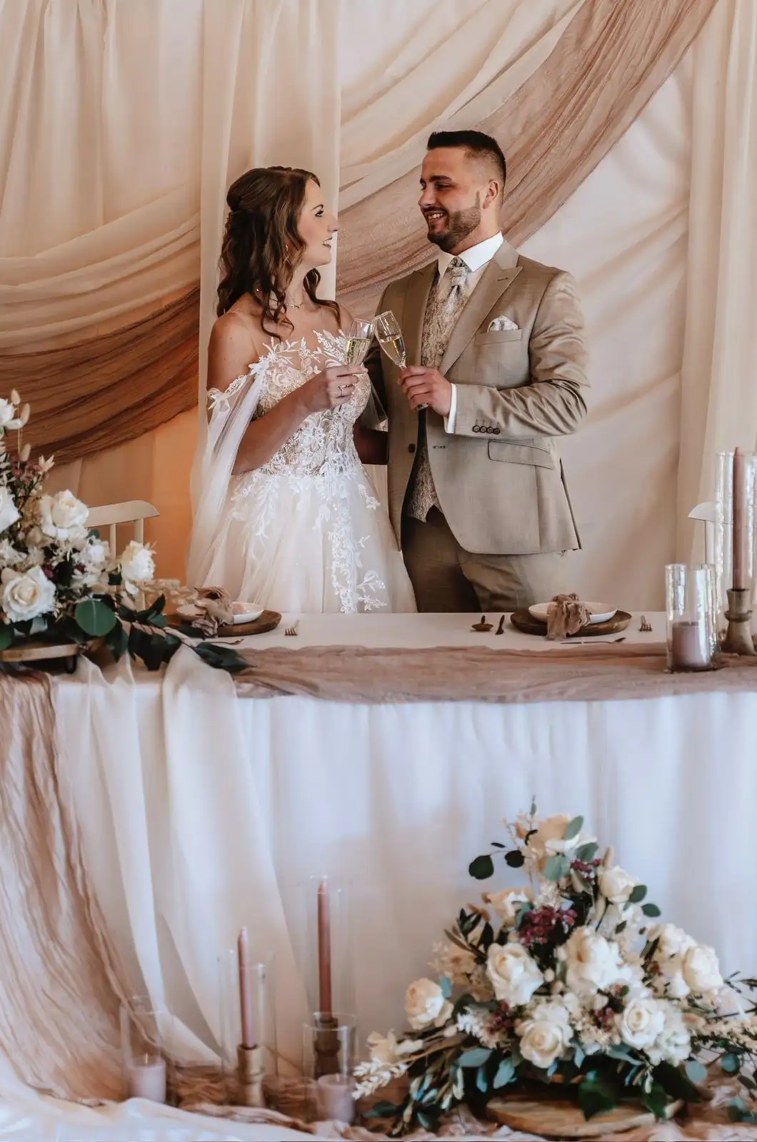 Man and woman in wedding clothes drinking together