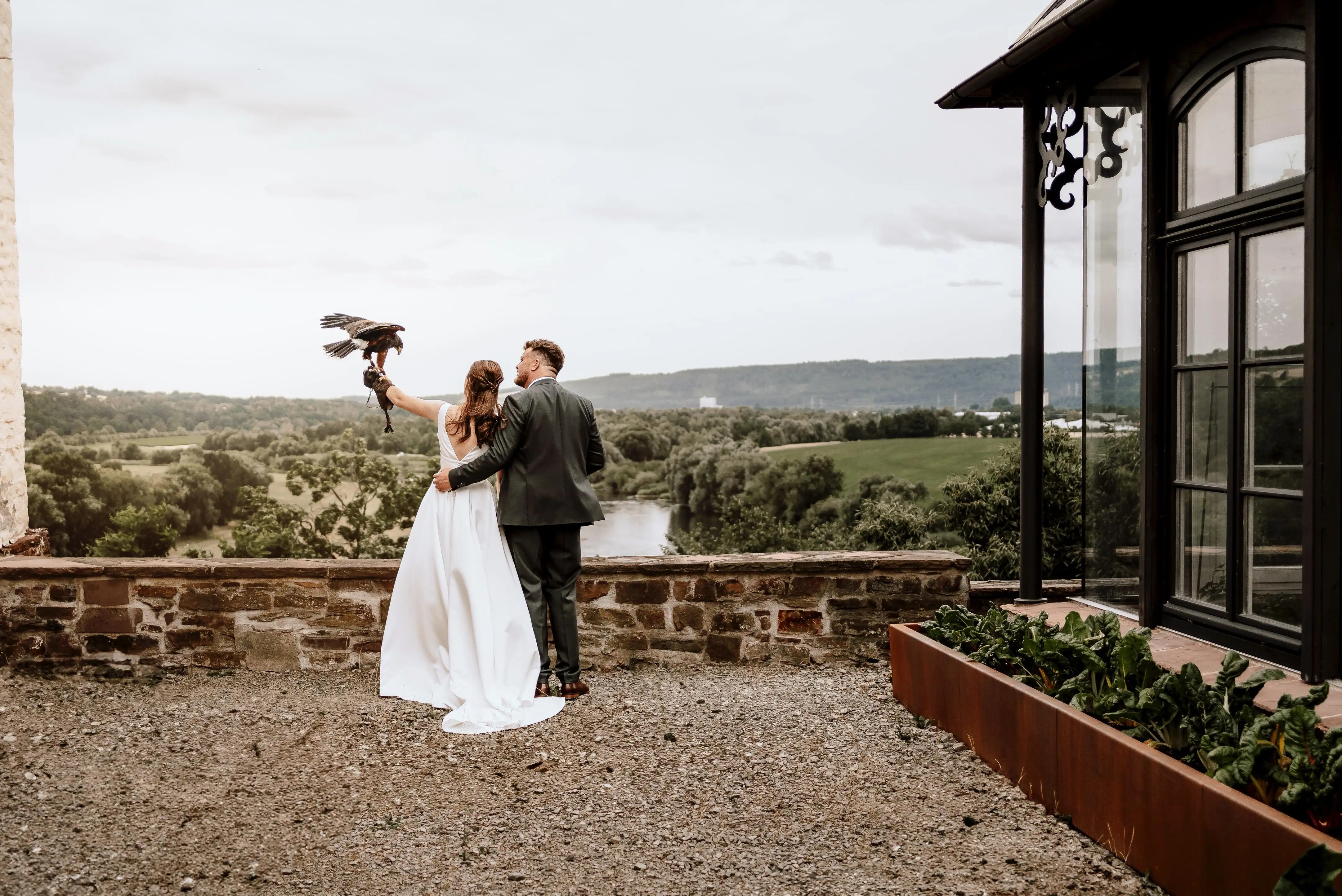man and woman in wedding clothes with eagle