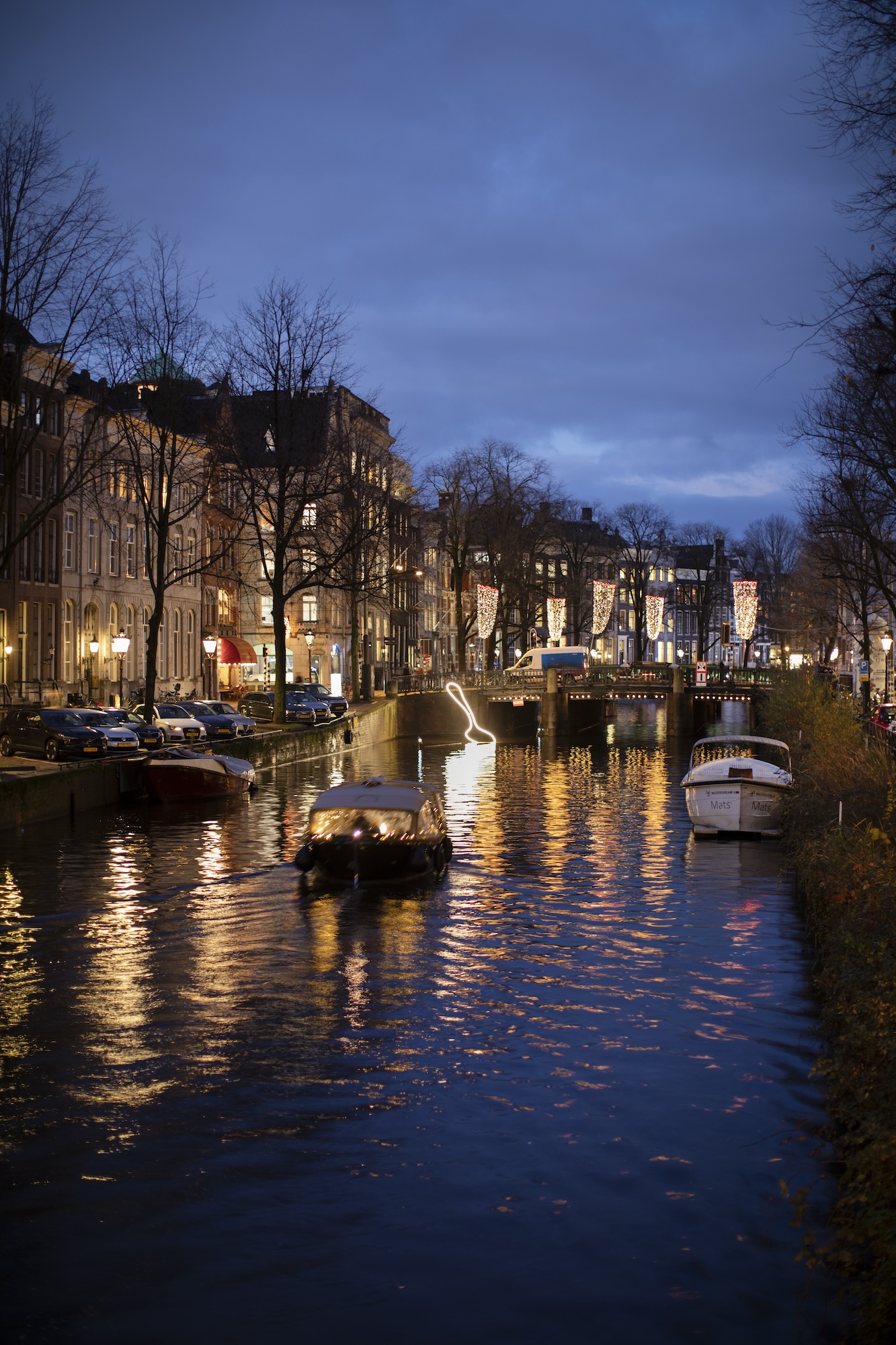 The spoonful light installation shown in a portrait image with boats around on the canal