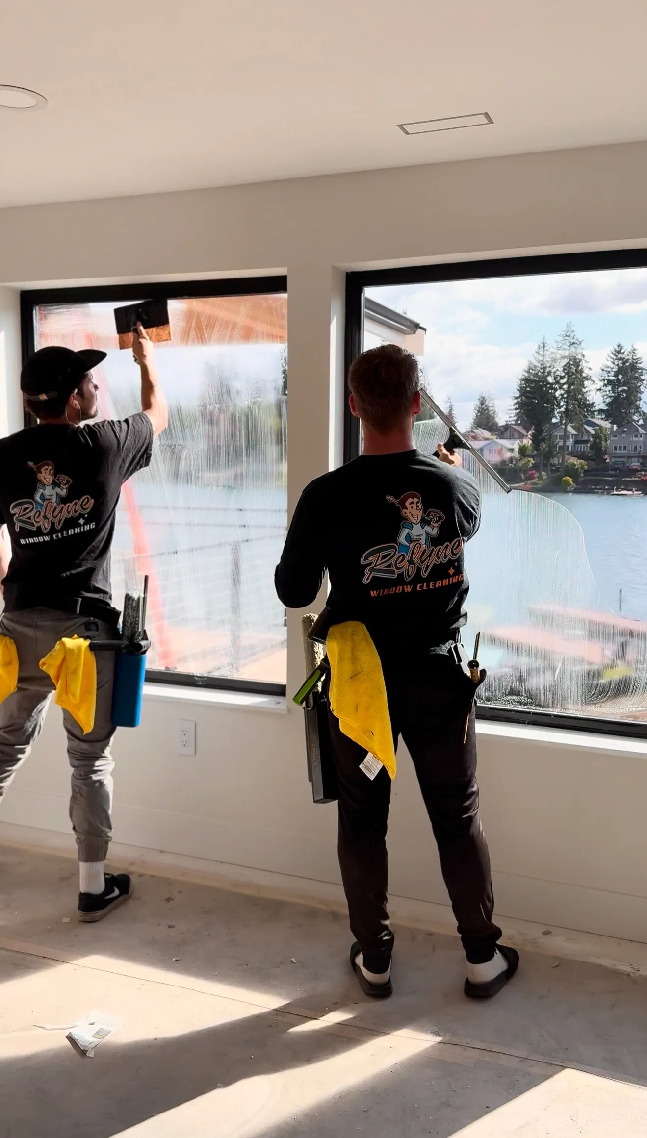 Window cleaners professionally cleaning interior windows