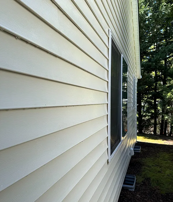 Clean, freshly washed home exterior siding, visibly free from algae and grime after Refyne Window Cleaning’s service
