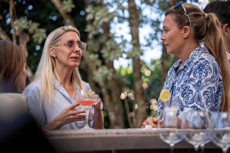 Guests catching up over cocktails under the trees