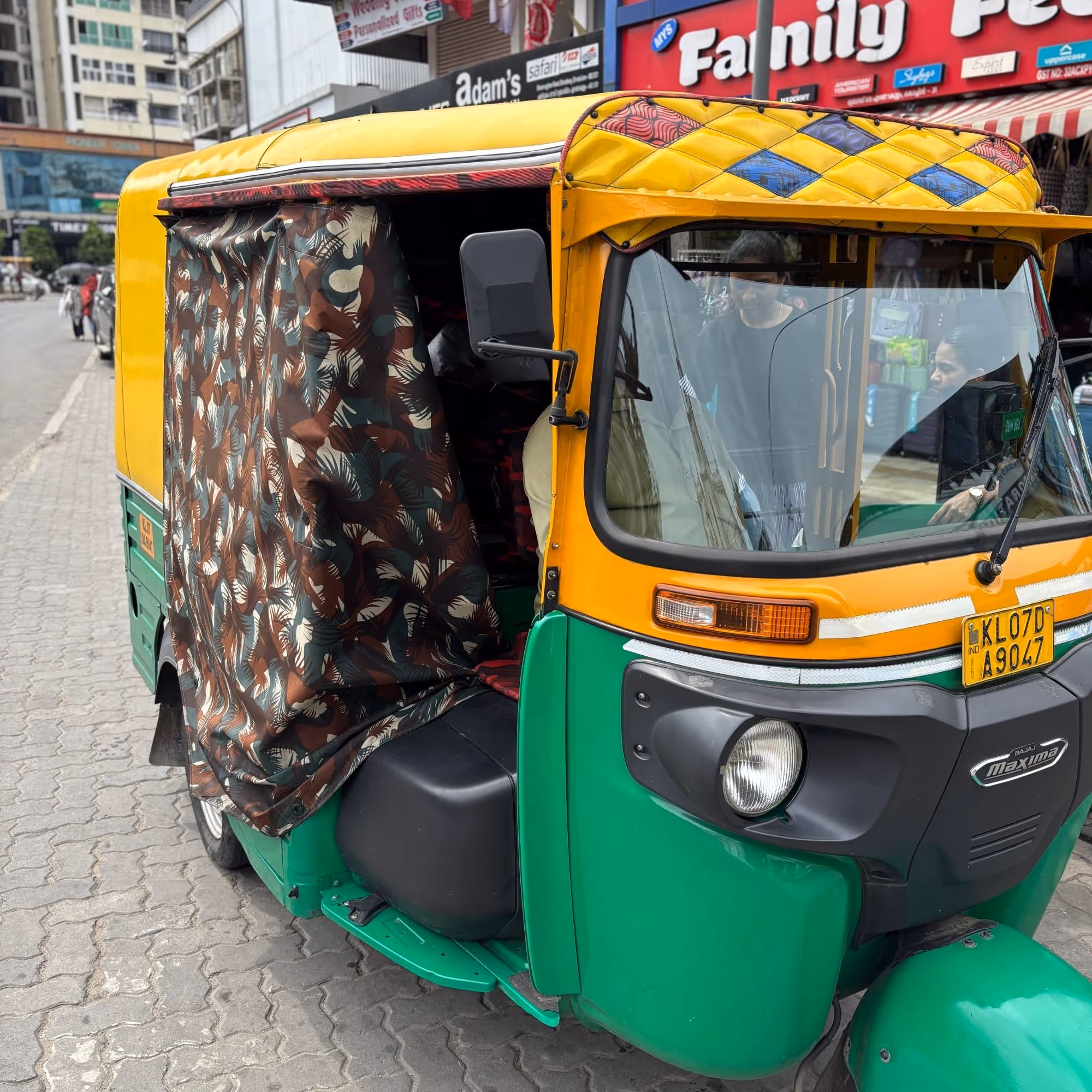 gap year to india exploring markets green and yellow tuktuk volunteering abroad