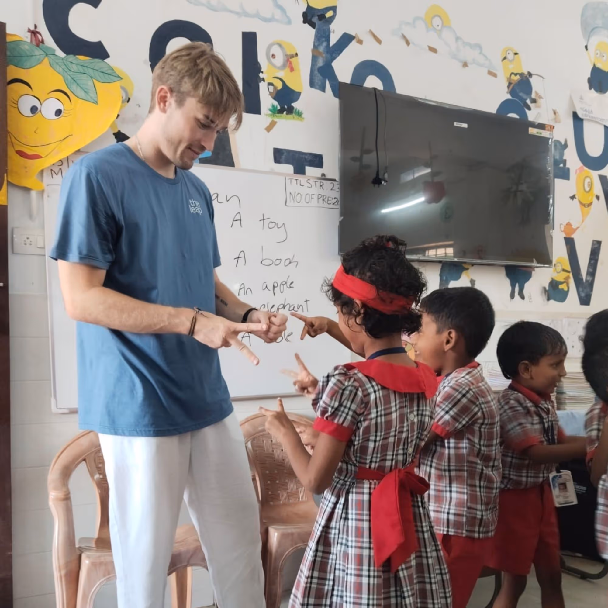 gap year to india volunteering in school young gap year student teaching children in classroom