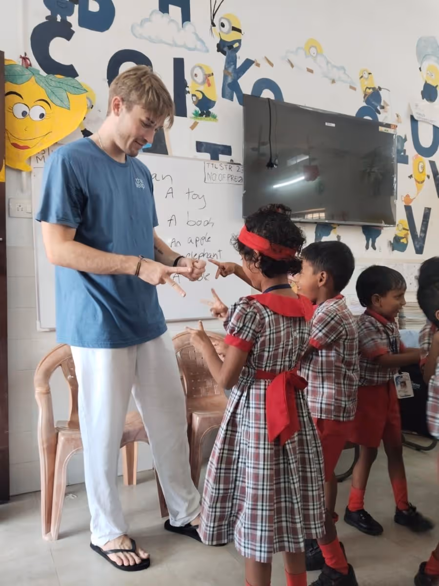 gap year india volunteering abroad in school young student wearing the leap tshirt teaching Indian children