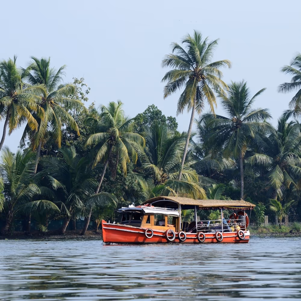 gap year india volunteering abroad western ghats red boat floating on the water palm trees