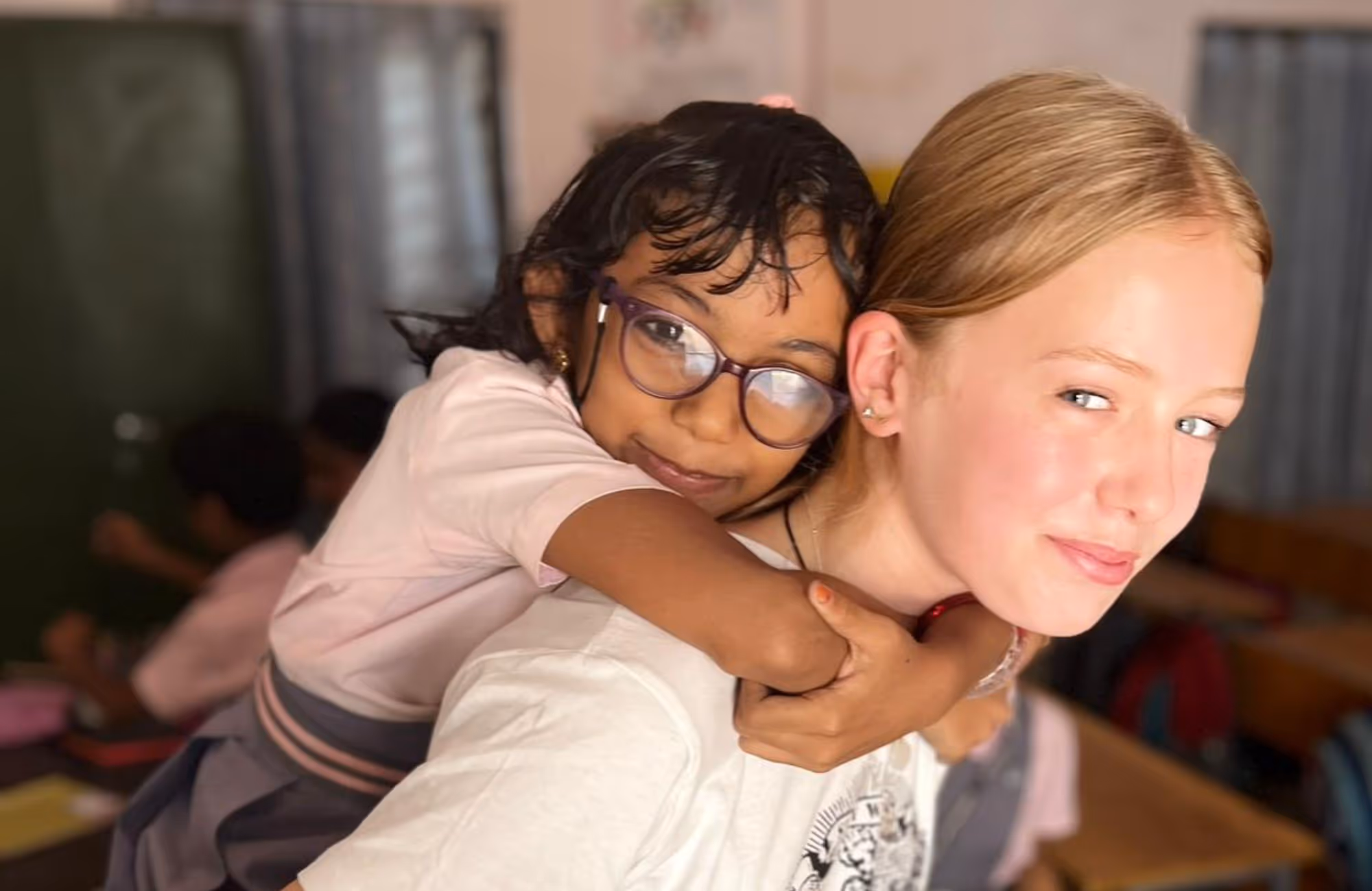 gap year india volunteering in school young girl on back of student 