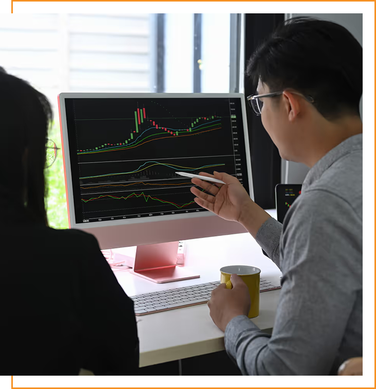 Confident woman in a blue shirt holding a blue folder standing in a modern office with glass walls.