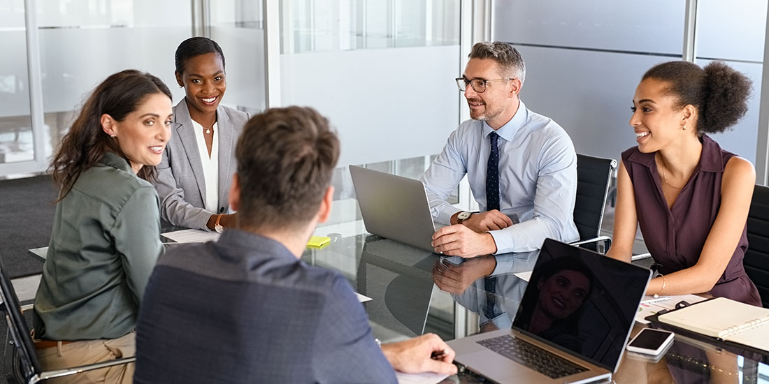 Governance executive committee sits around a conference table. 