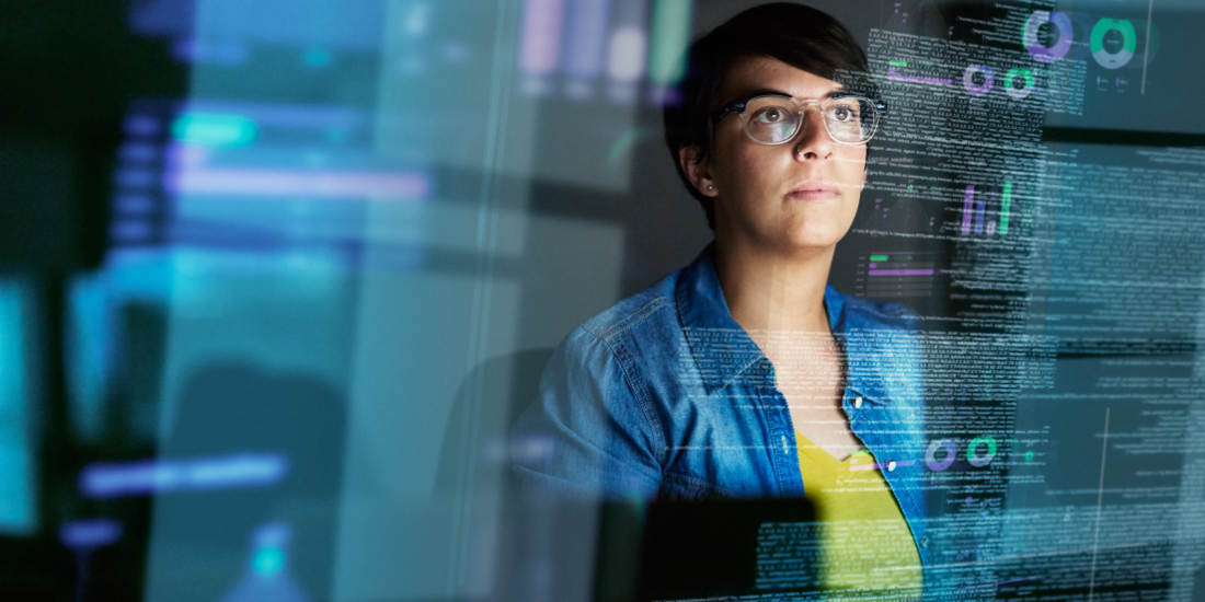 A tech employee works at a computer screen with code overlaid on the image to show the forward deployed engineering work they are attempting.