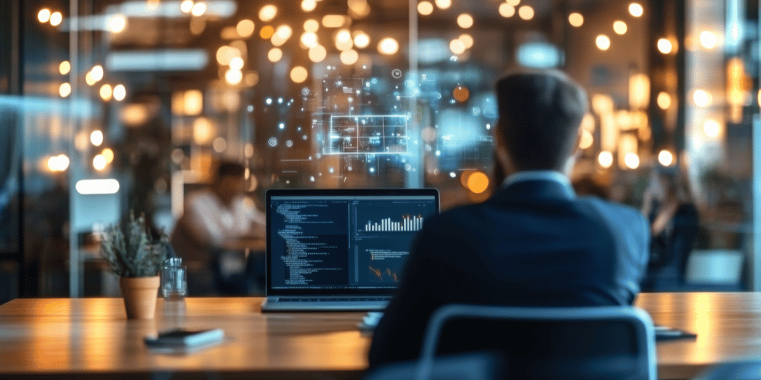 view of man from behind looking at computer screen with bright lights