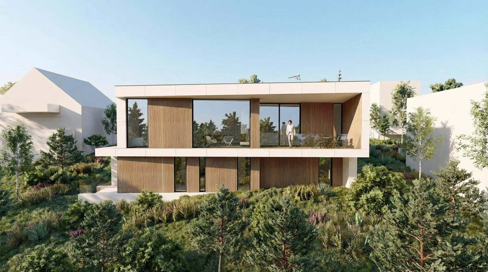 Arkitekttegnet bolig i to plan med trespiler og balkong, plassert i kupert, grønt terreng