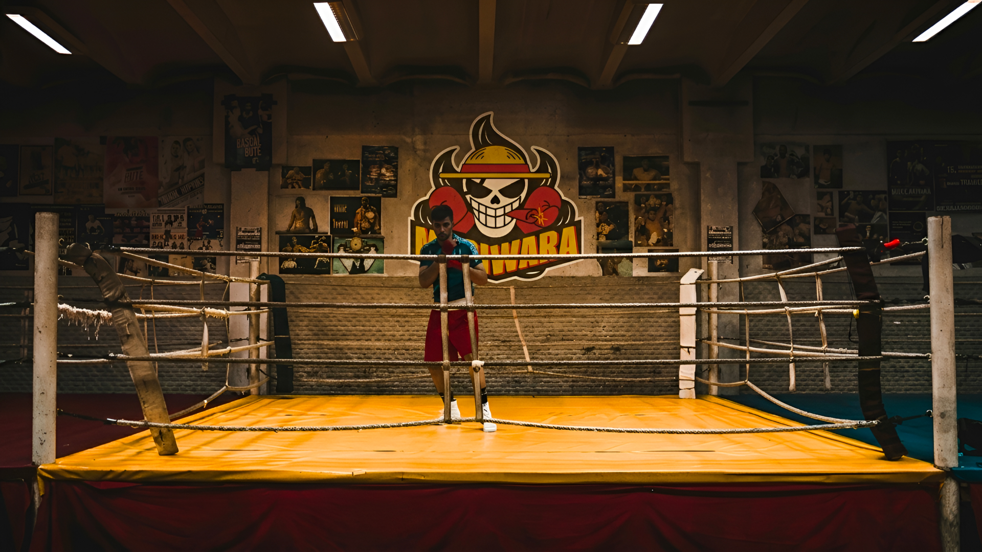 Boxer standing in a ring with the MMA athlete brand logo displayed behind