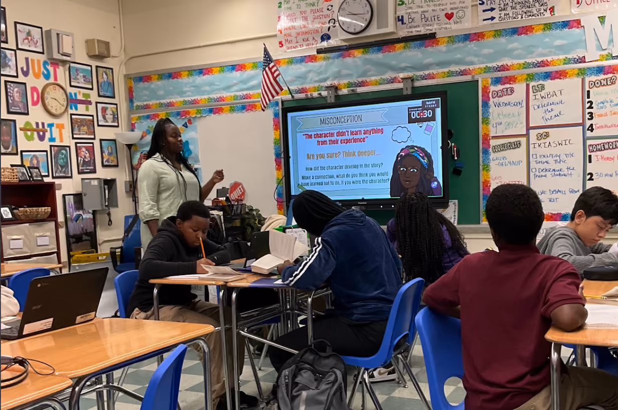 Teacher leads a literacy lesson using an interactive classroom smartboard