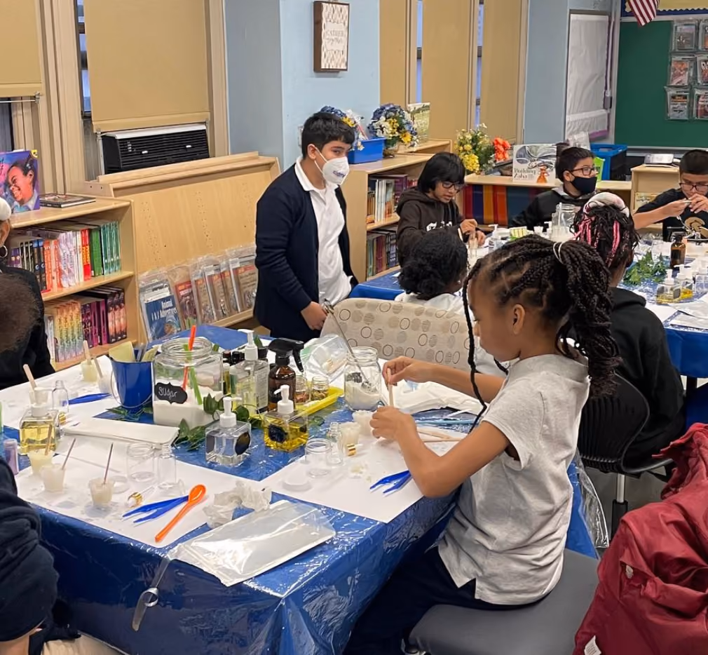 Students making natural products during a hands-on science workshop in the library