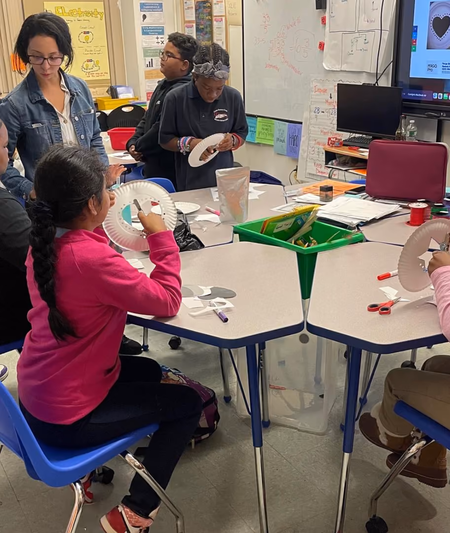 Students creating paper plate crafts during a classroom activity