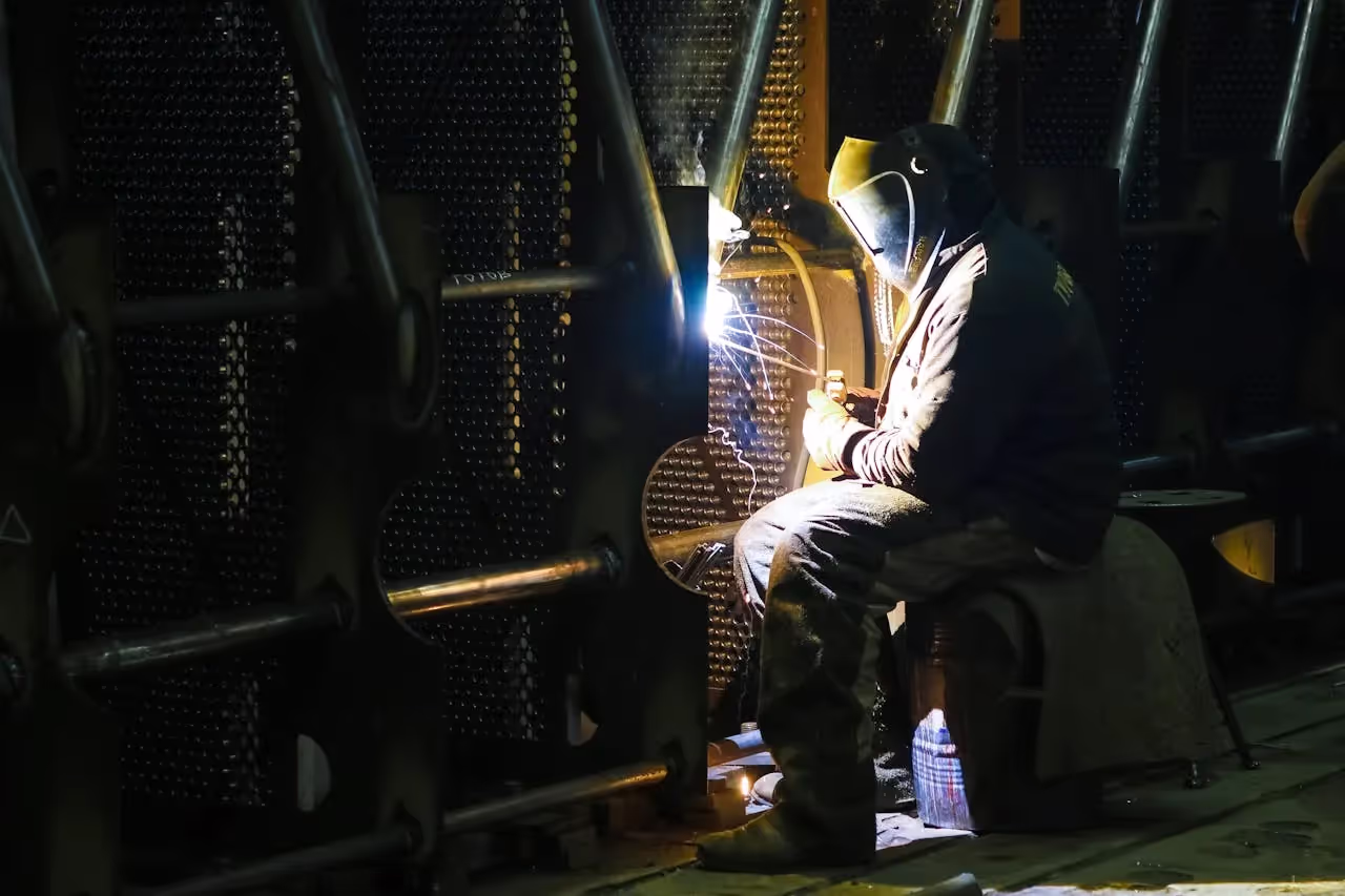 Person welding metal structure.