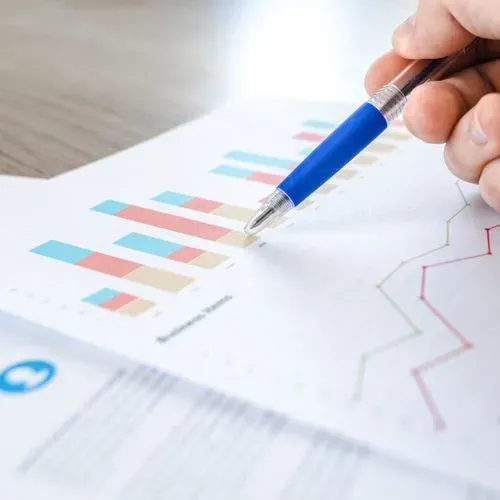 Hand pointing at bar chart.