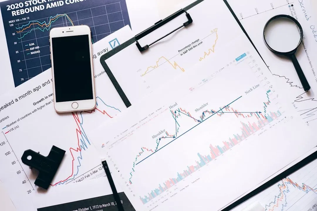Desk with smartphone and charts.