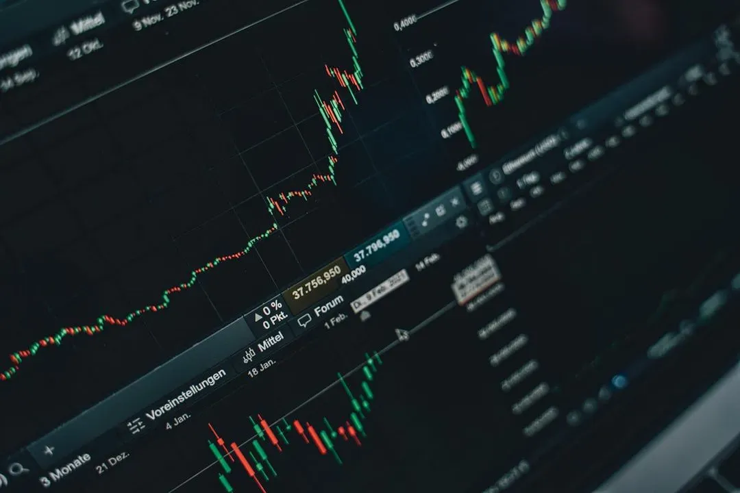 Stock market chart on screen.