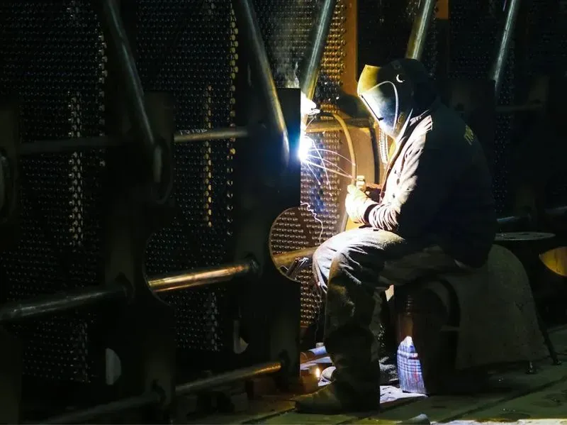 Person welding a blow torch.