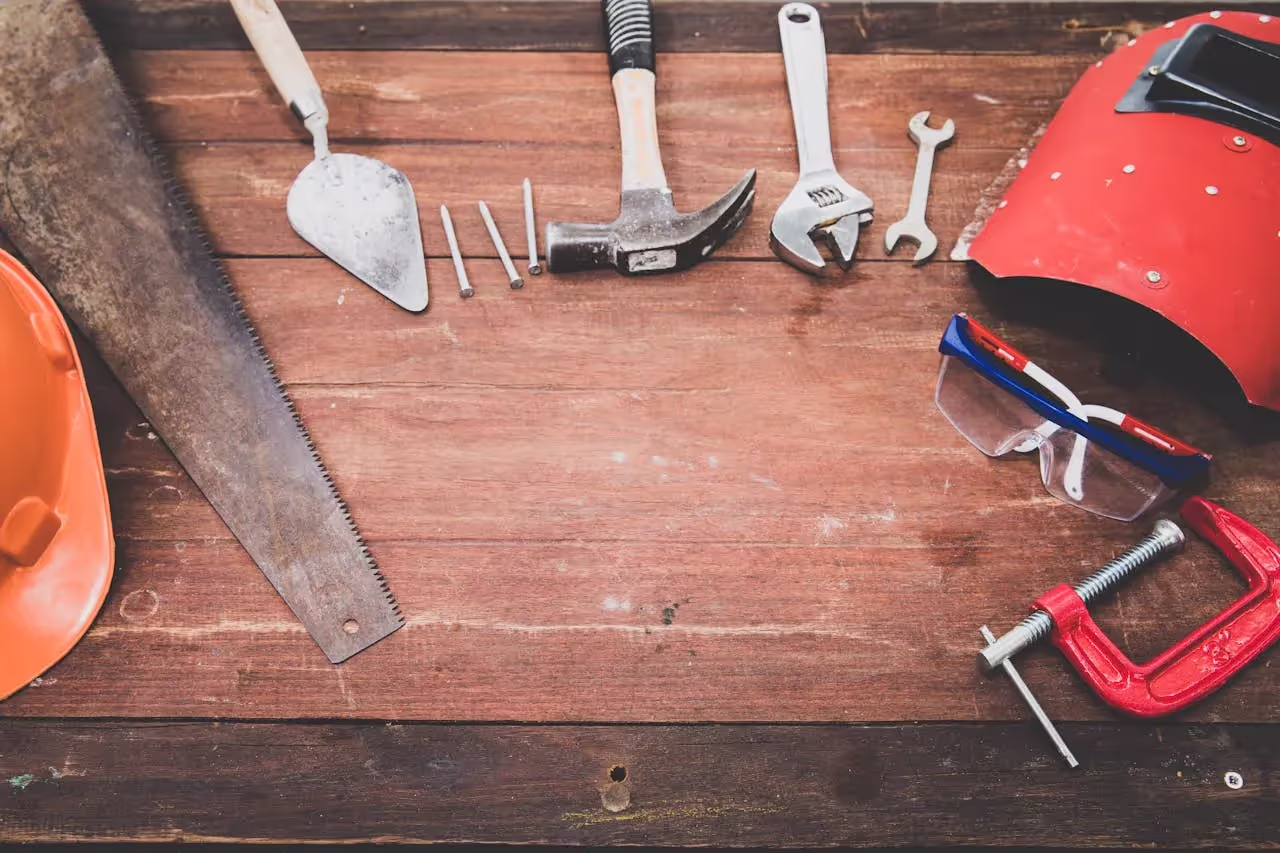 Tools arranged on wooden table.