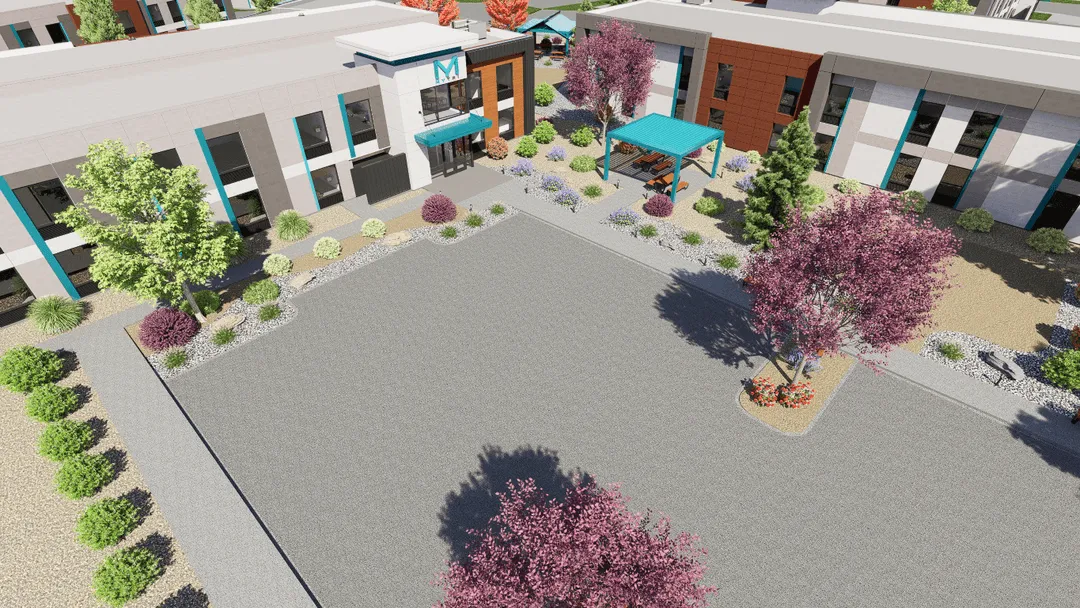 An aerial view of a building with a picnic area.