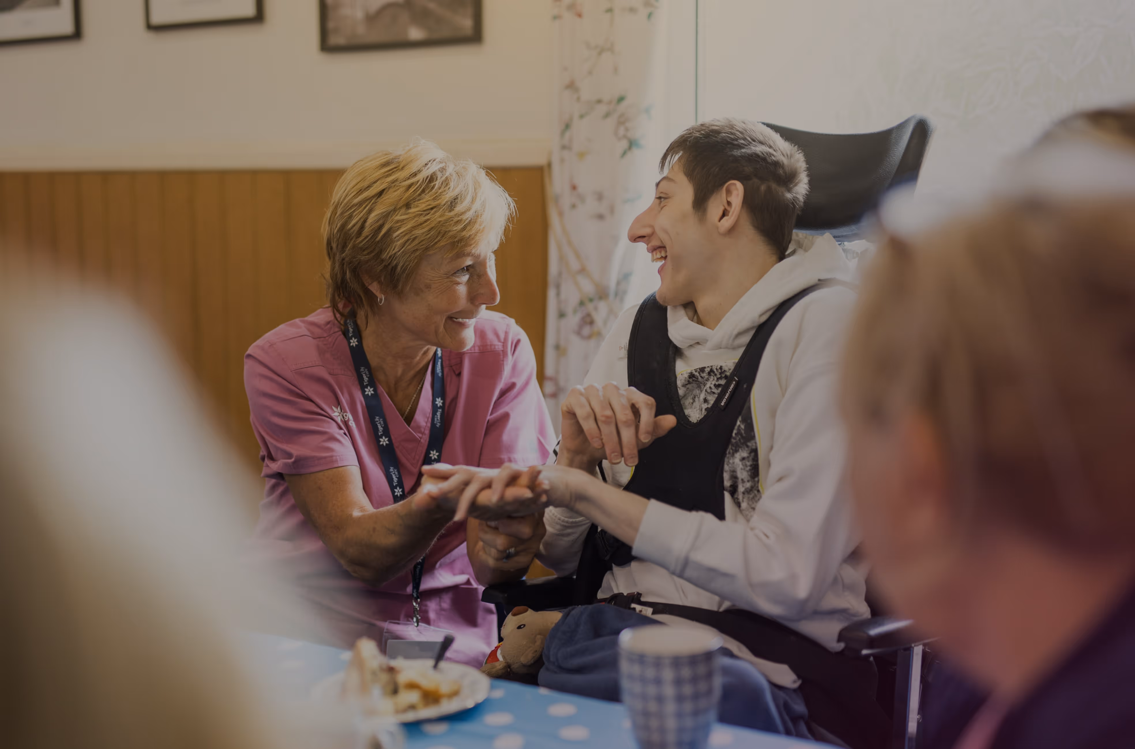 Founder of Tiger Lily Care laughing with complex care client