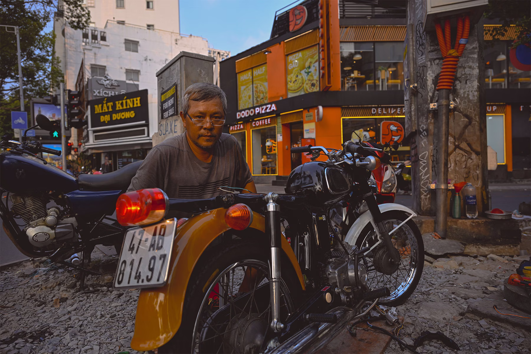 Man fixing motorbike in Vietnam