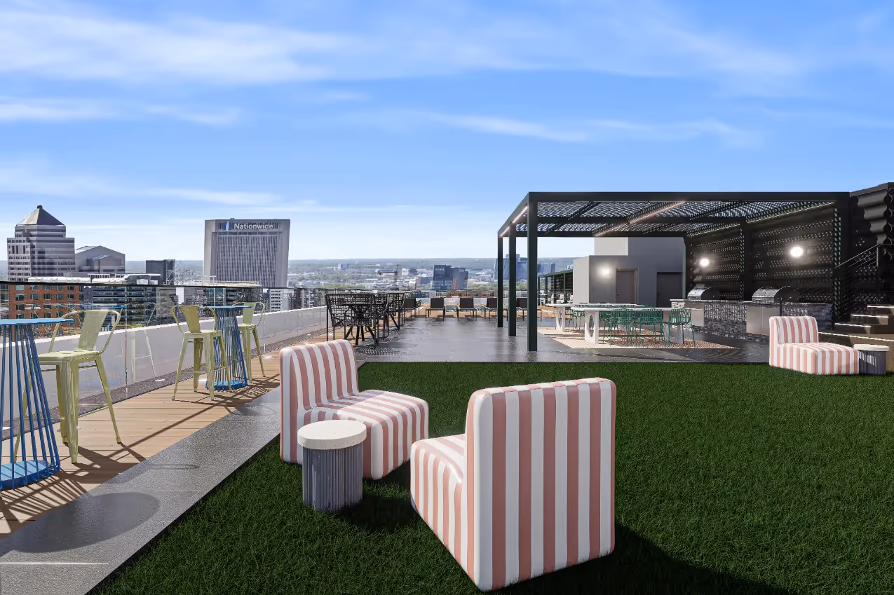 Expansive rooftop terrace with artificial turf, striped lounge chairs, and a grilling station, showcasing panoramic city views from Continental Tower in Columbus, Ohio.