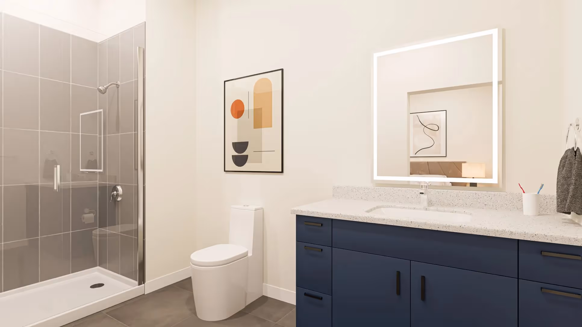 Modern bathroom with a spacious vanity, illuminated mirror, walk-in shower, and contemporary design at Continental Tower in Columbus, Ohio.