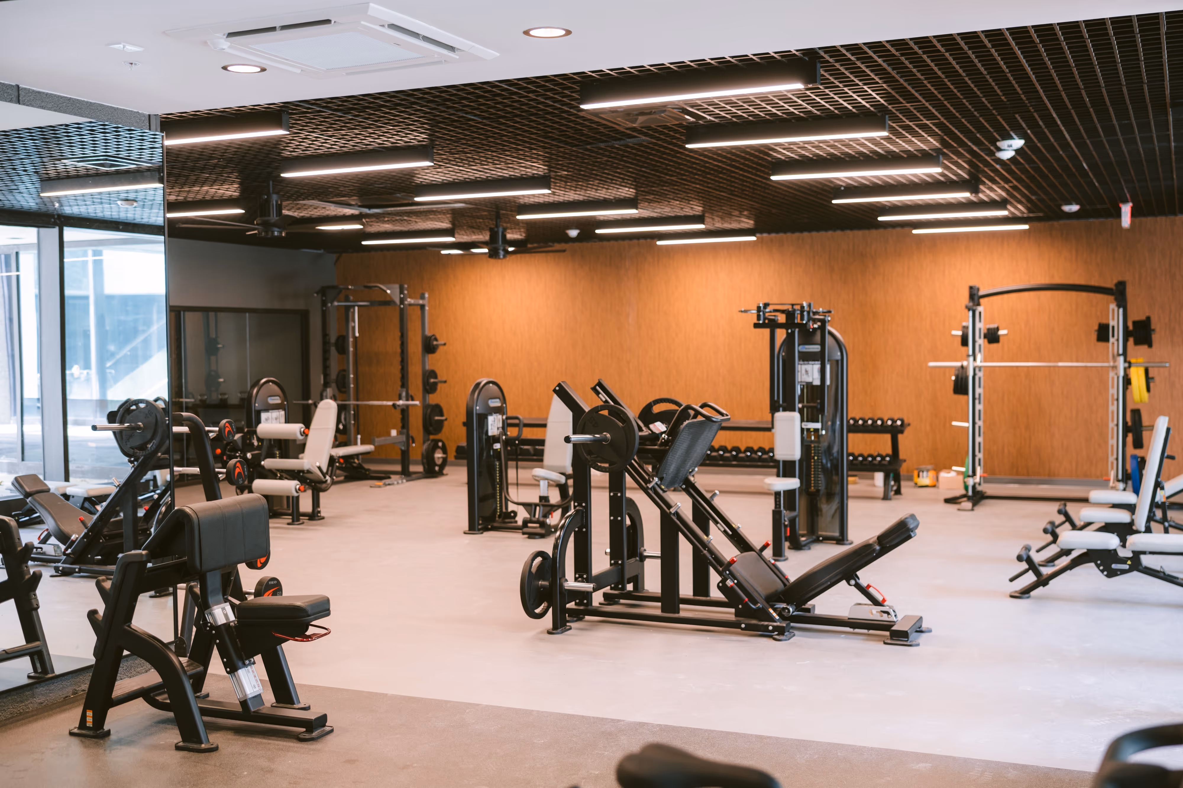 State-of-the-art fitness center with a unique indoor turf area, exercise equipment, and large windows, available to residents of Continental Tower in Columbus, Ohio.