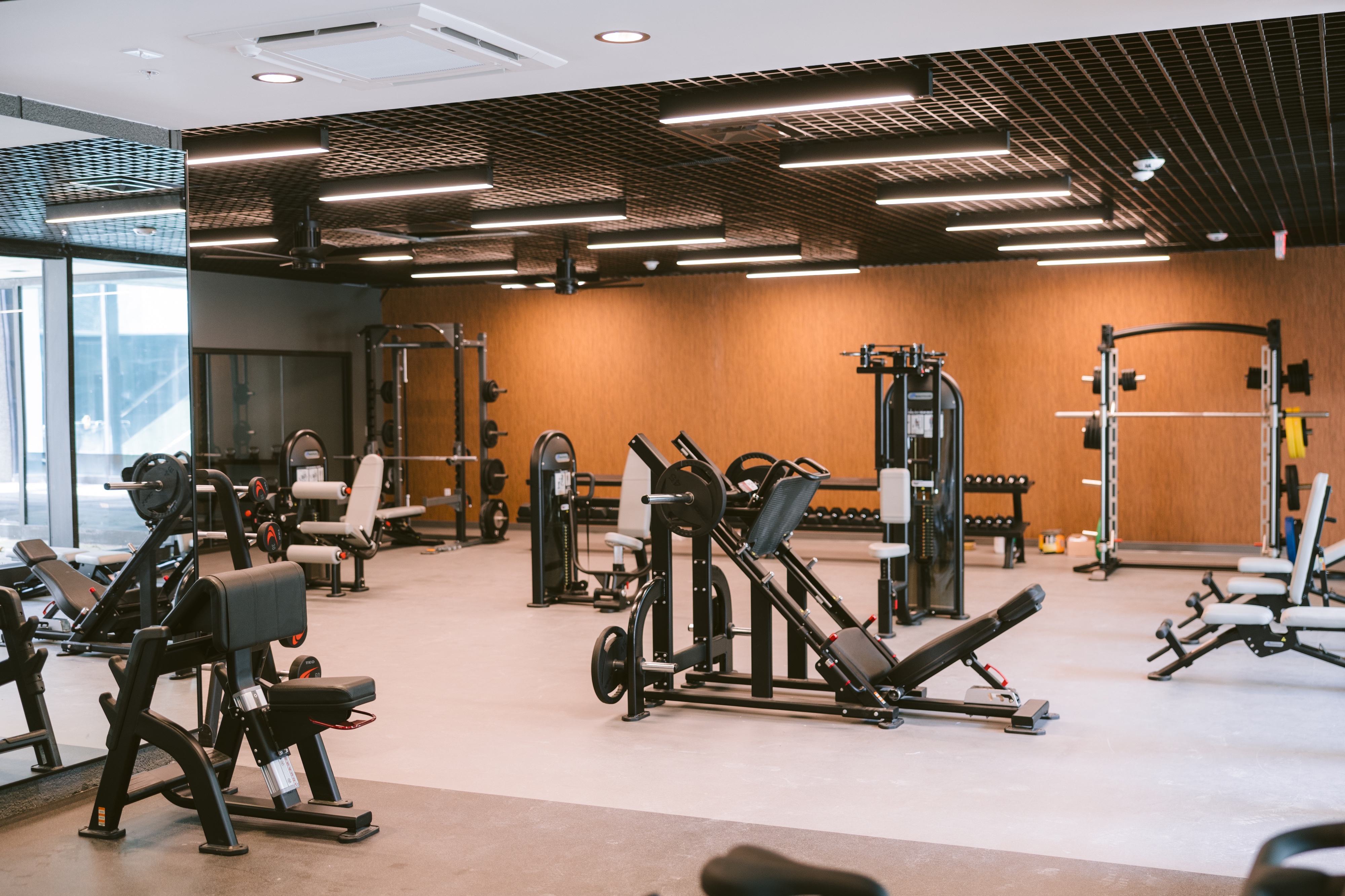 State-of-the-art fitness center with a unique indoor turf area, exercise equipment, and large windows, available to residents of Continental Tower in Columbus, Ohio.