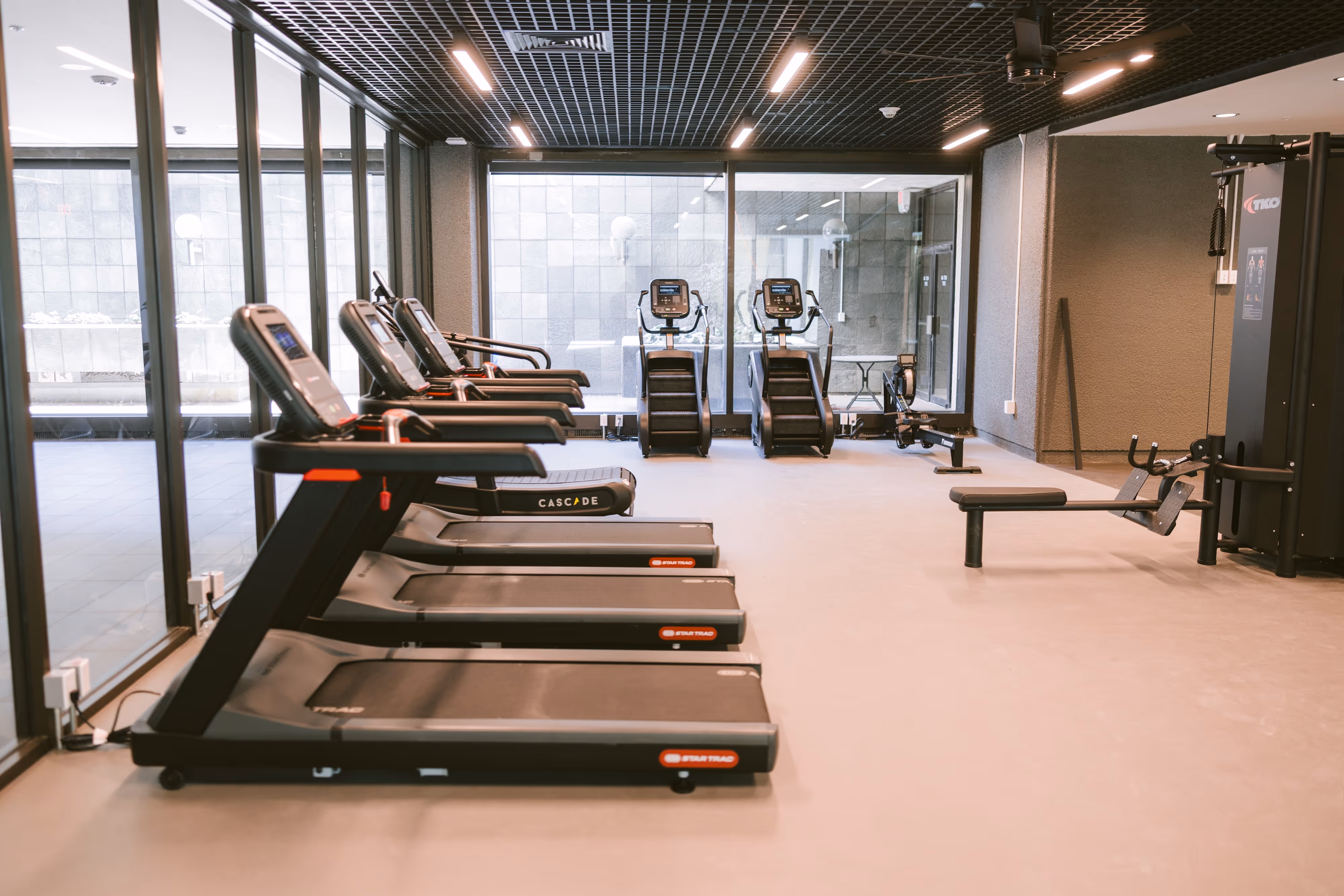 Extensive fitness center with a wide array of exercise equipment, free weights, and ample space for various workouts, at Continental Tower in Columbus, Ohio.