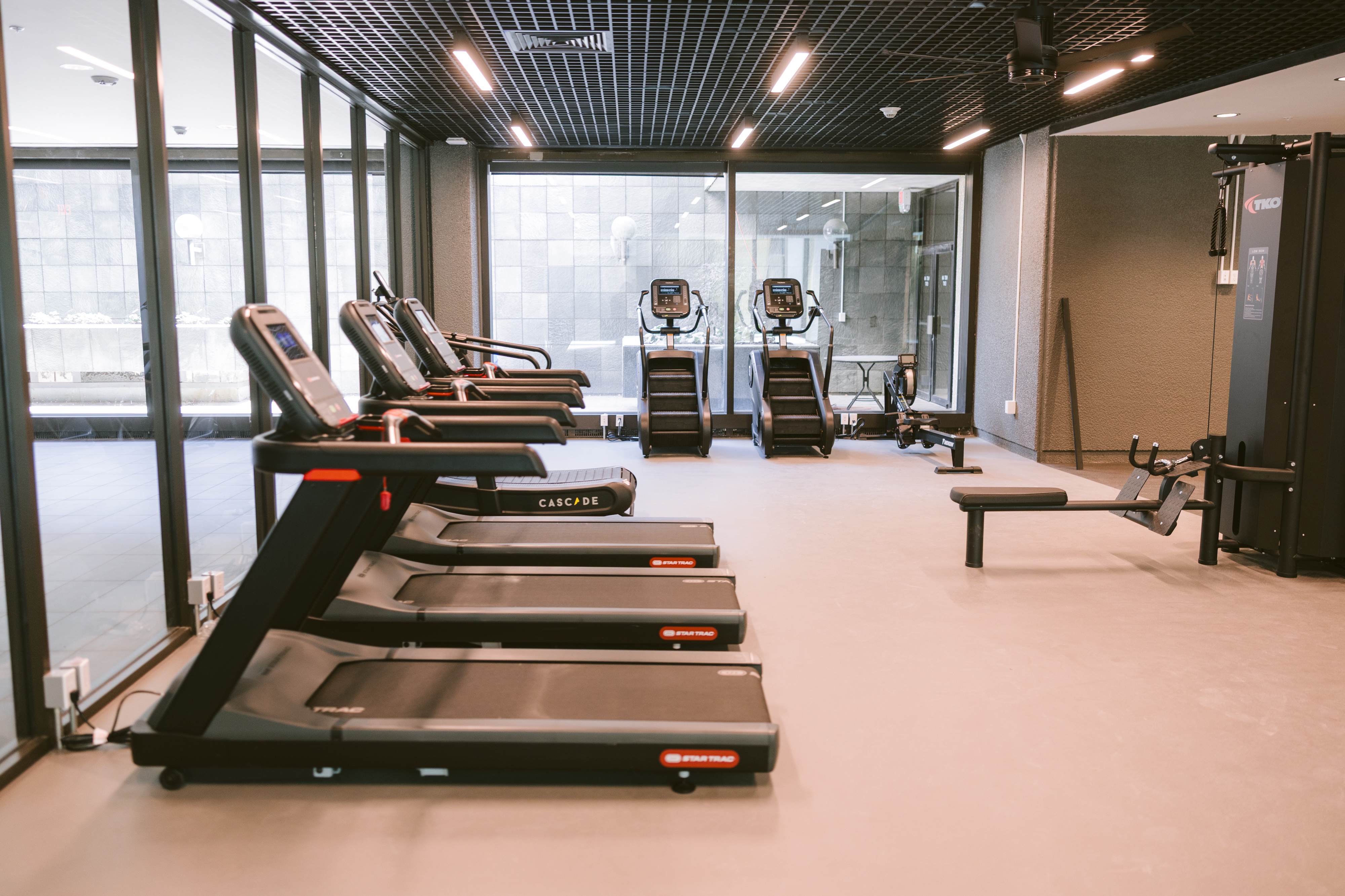 Extensive fitness center with a wide array of exercise equipment, free weights, and ample space for various workouts, at Continental Tower in Columbus, Ohio.