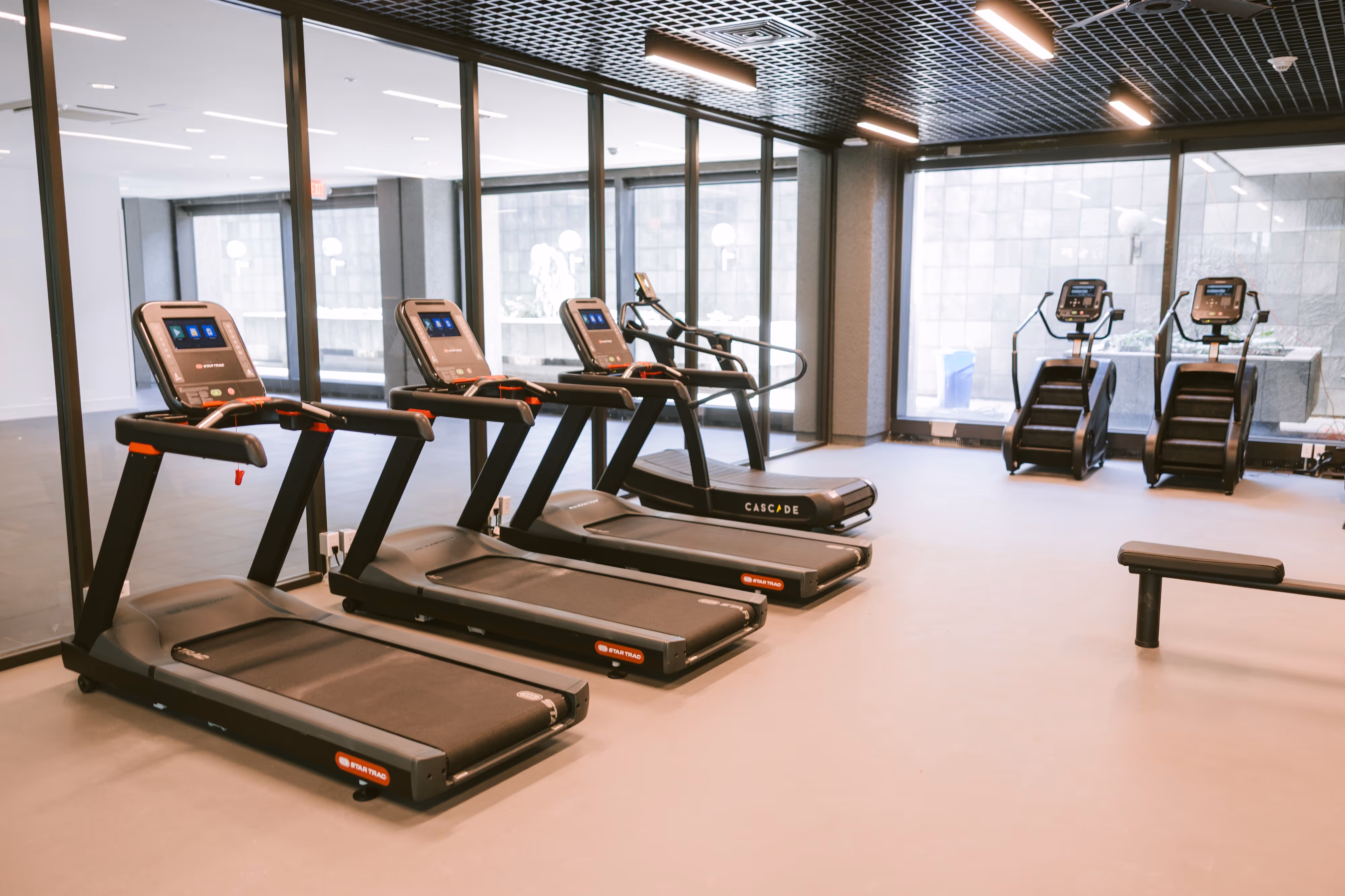 State-of-the-art fitness center with a unique indoor turf area, exercise equipment, and large windows, available to residents of Continental Tower in Columbus, Ohio.