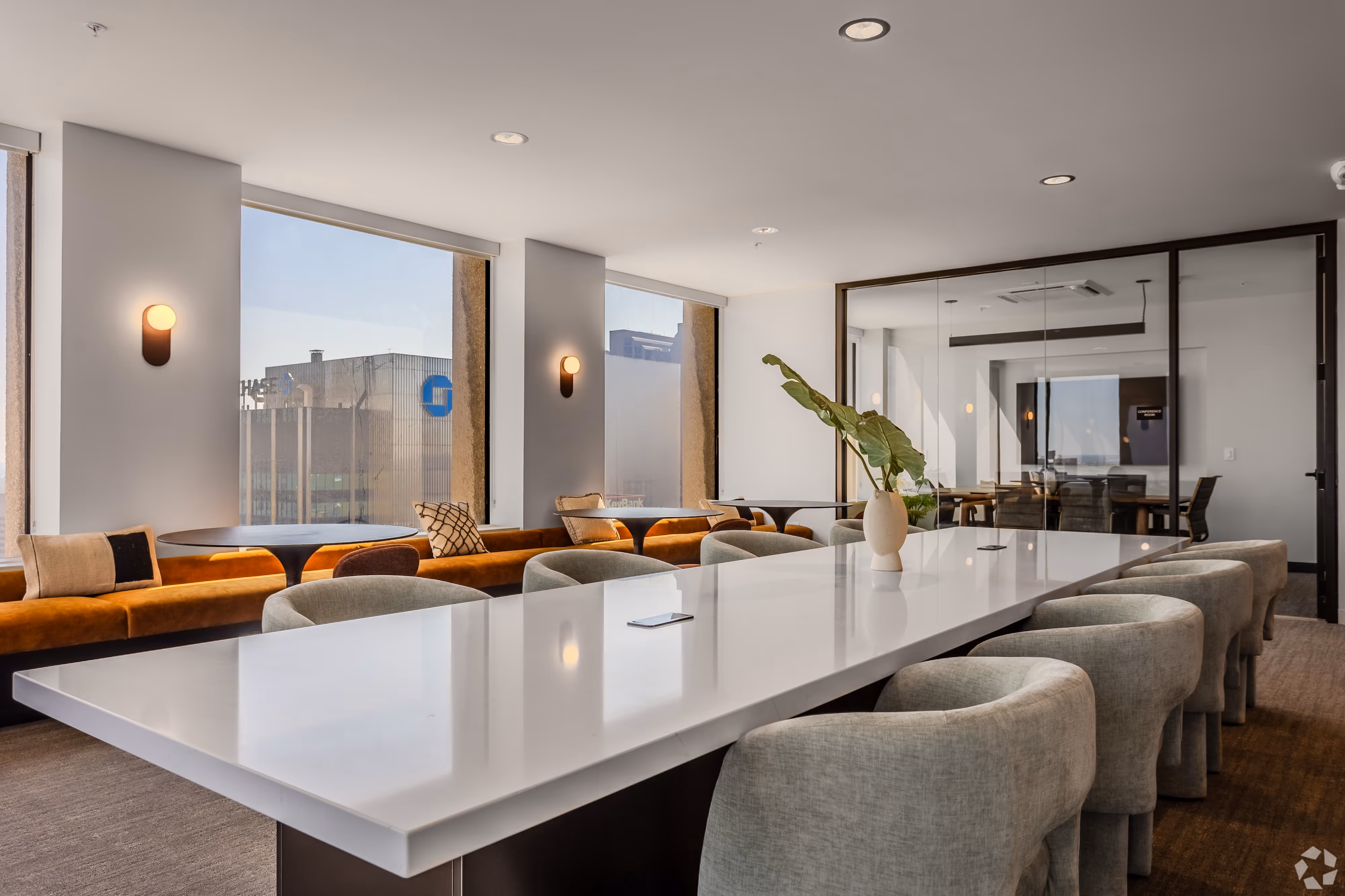 Luxurious resident lounge area with comfortable sofas and a modern bar setup, offering stunning city views from Continental Tower in Columbus, Ohio.