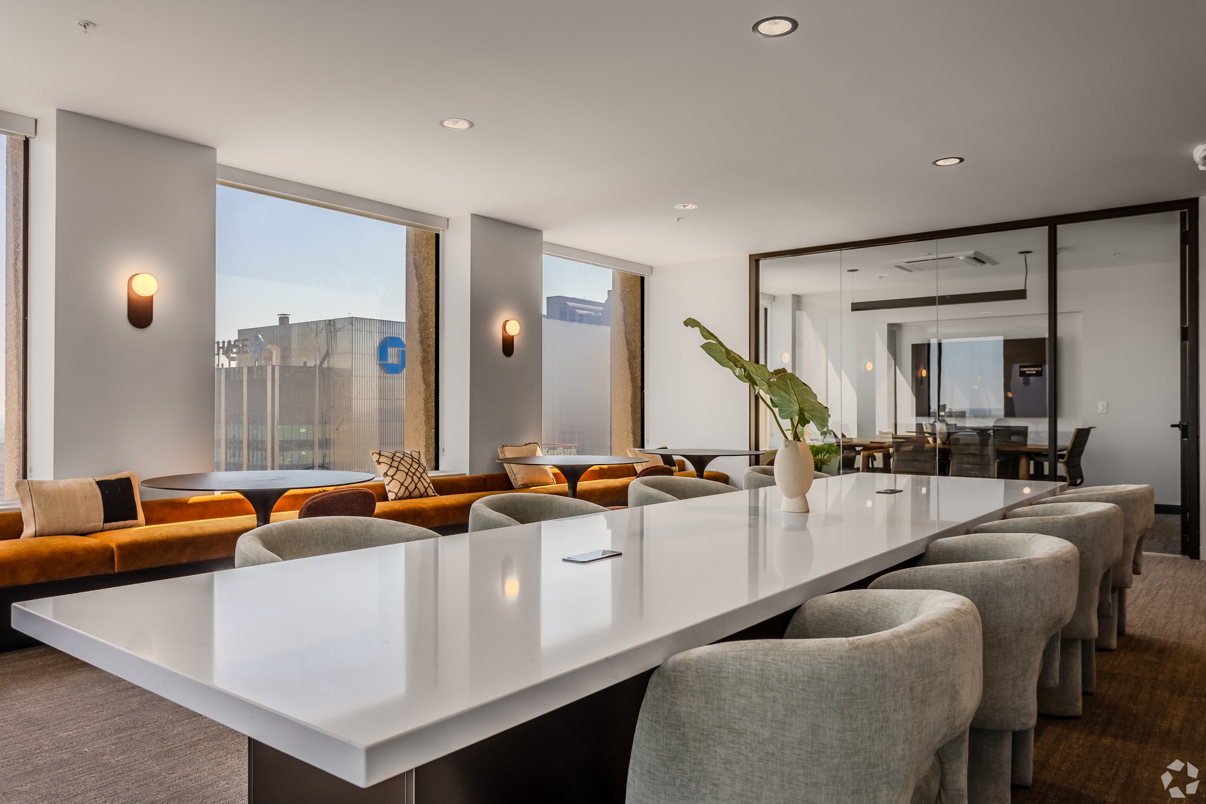 Luxurious resident lounge area with comfortable sofas and a modern bar setup, offering stunning city views from Continental Tower in Columbus, Ohio.