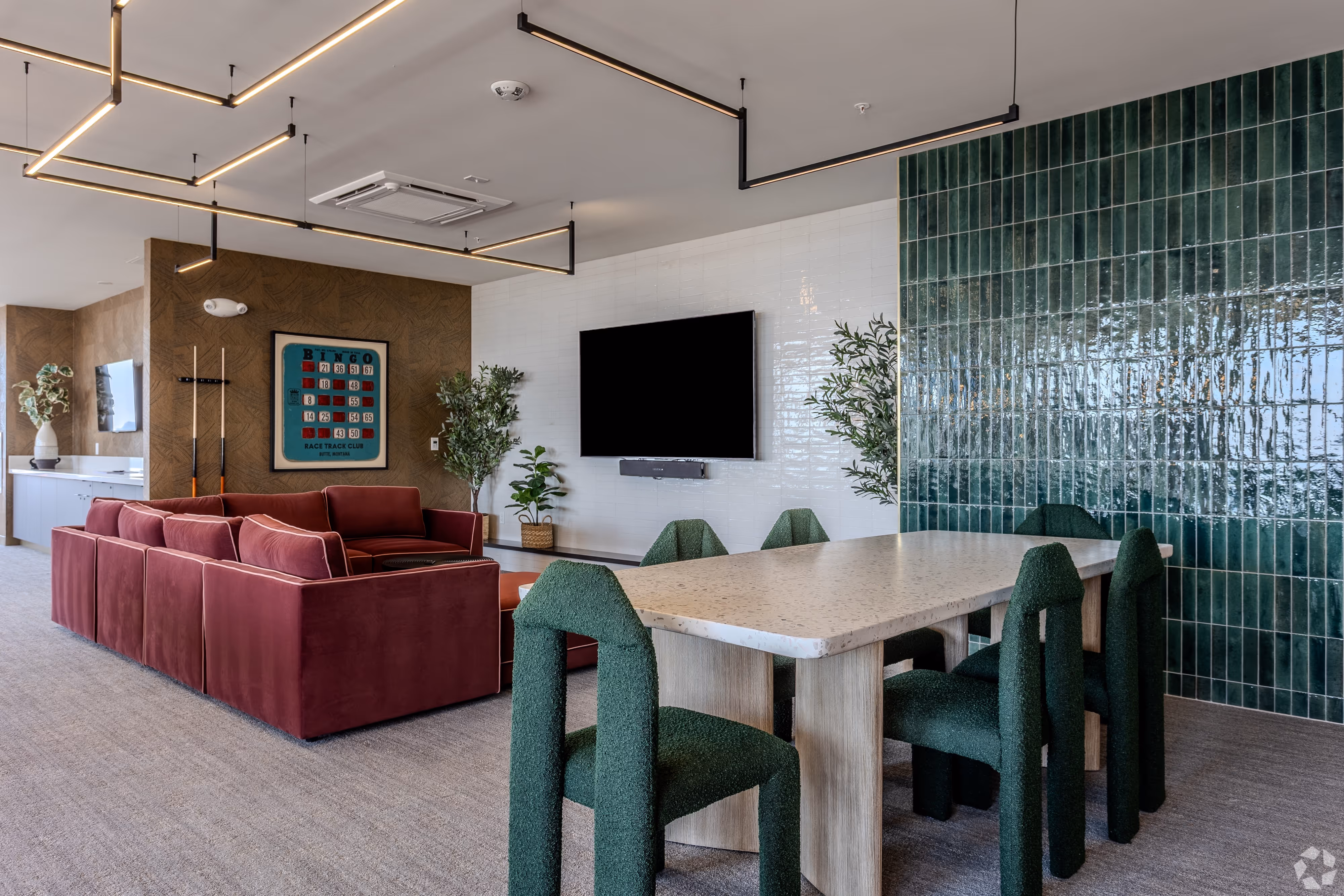 Stylish resident lounge and co-working space with various seating options, including a bar and tables, and city views, at Continental Tower in Columbus, Ohio.