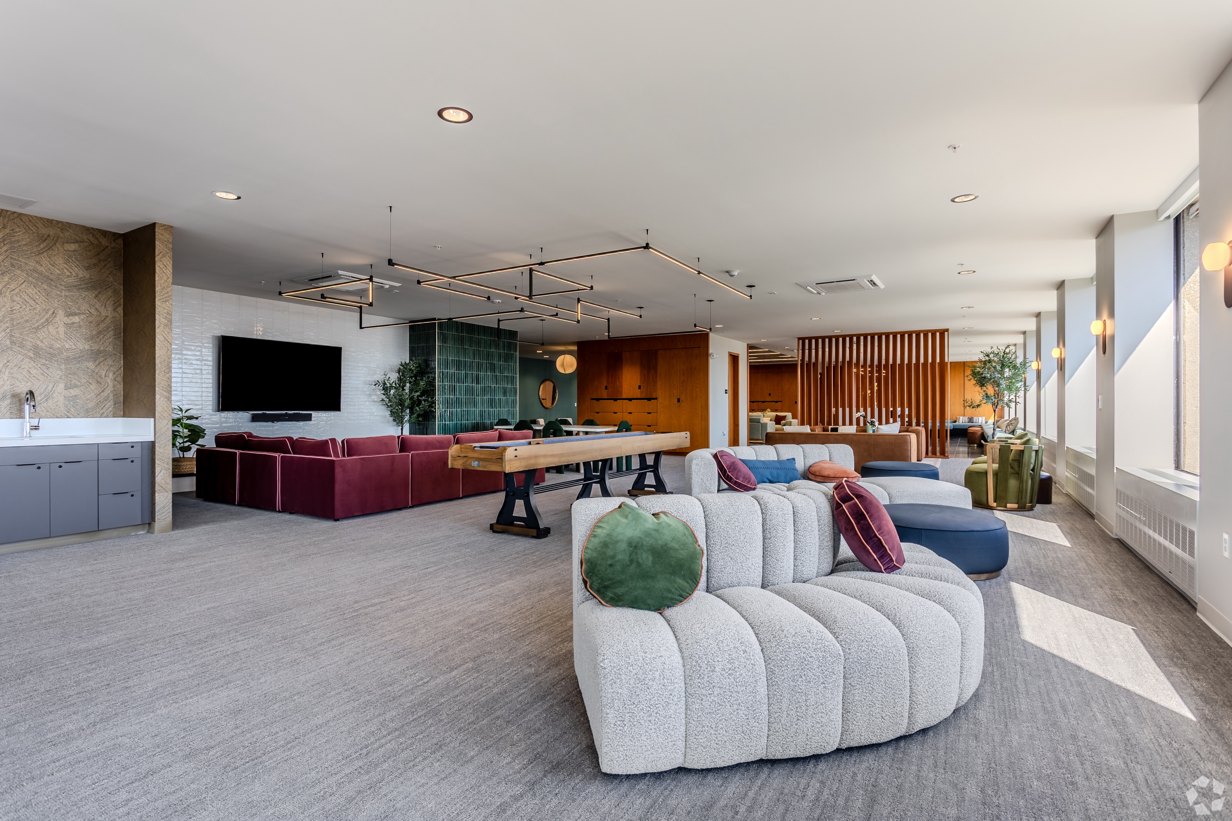 Bright apartment living and dining room with large windows offering panoramic city views of downtown Columbus, Ohio, from Continental Tower.