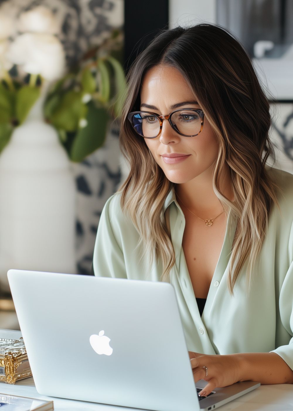Photo of woman looking at laptop screen.
