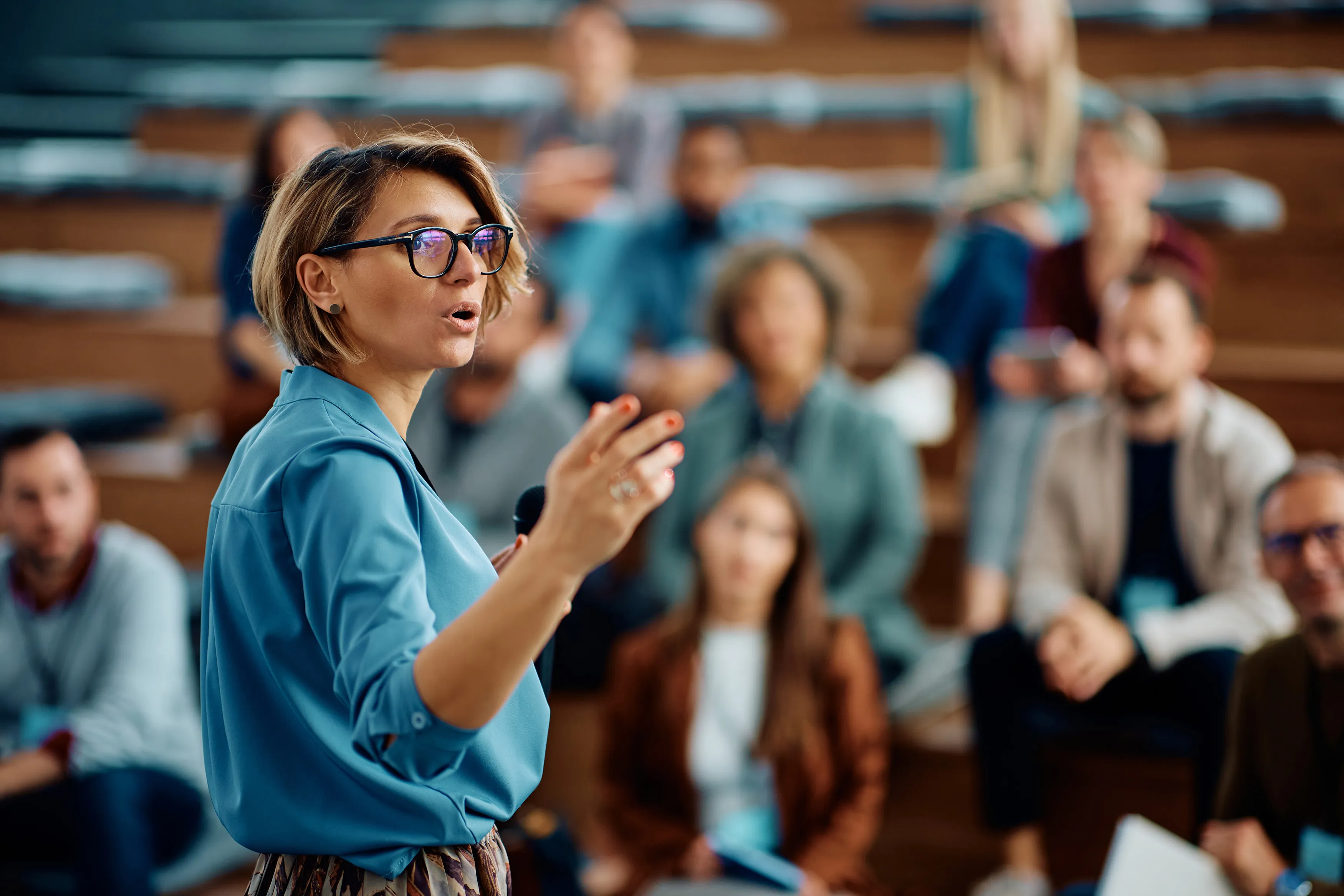 Speaker addressing an audience in a lecture hall