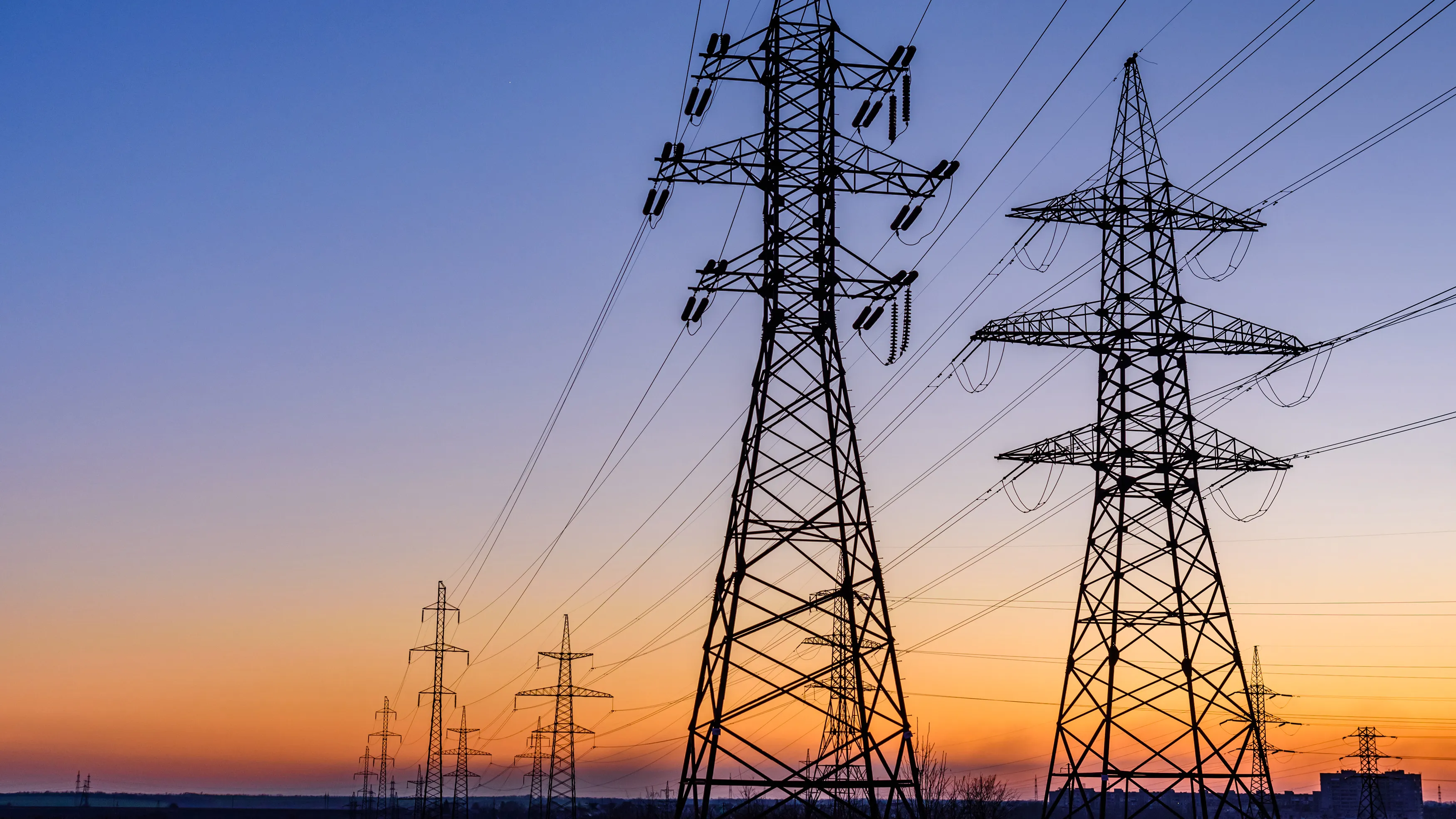 Electricity transmission towers at sunset