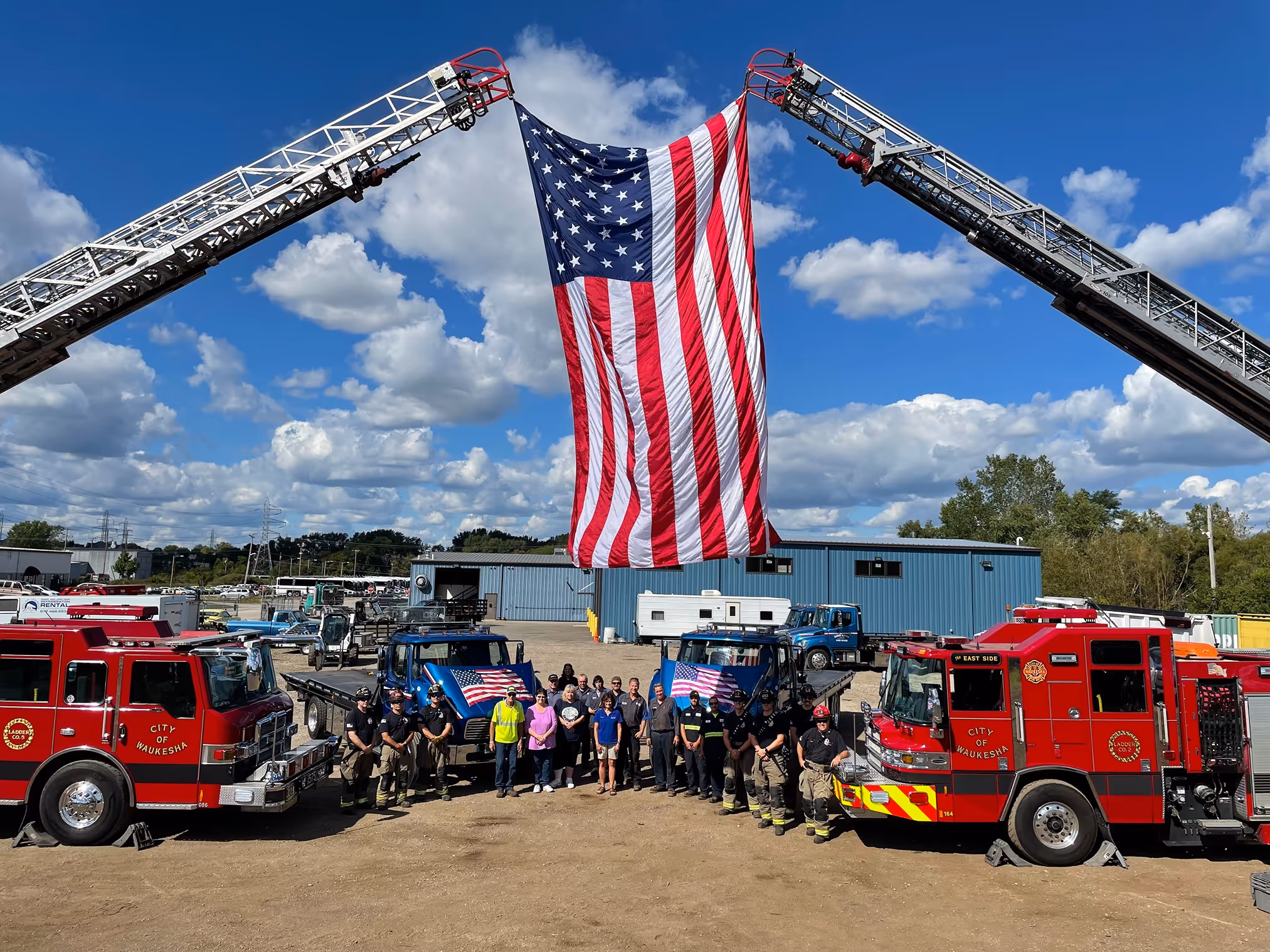 Fire trucks with american flag between them
