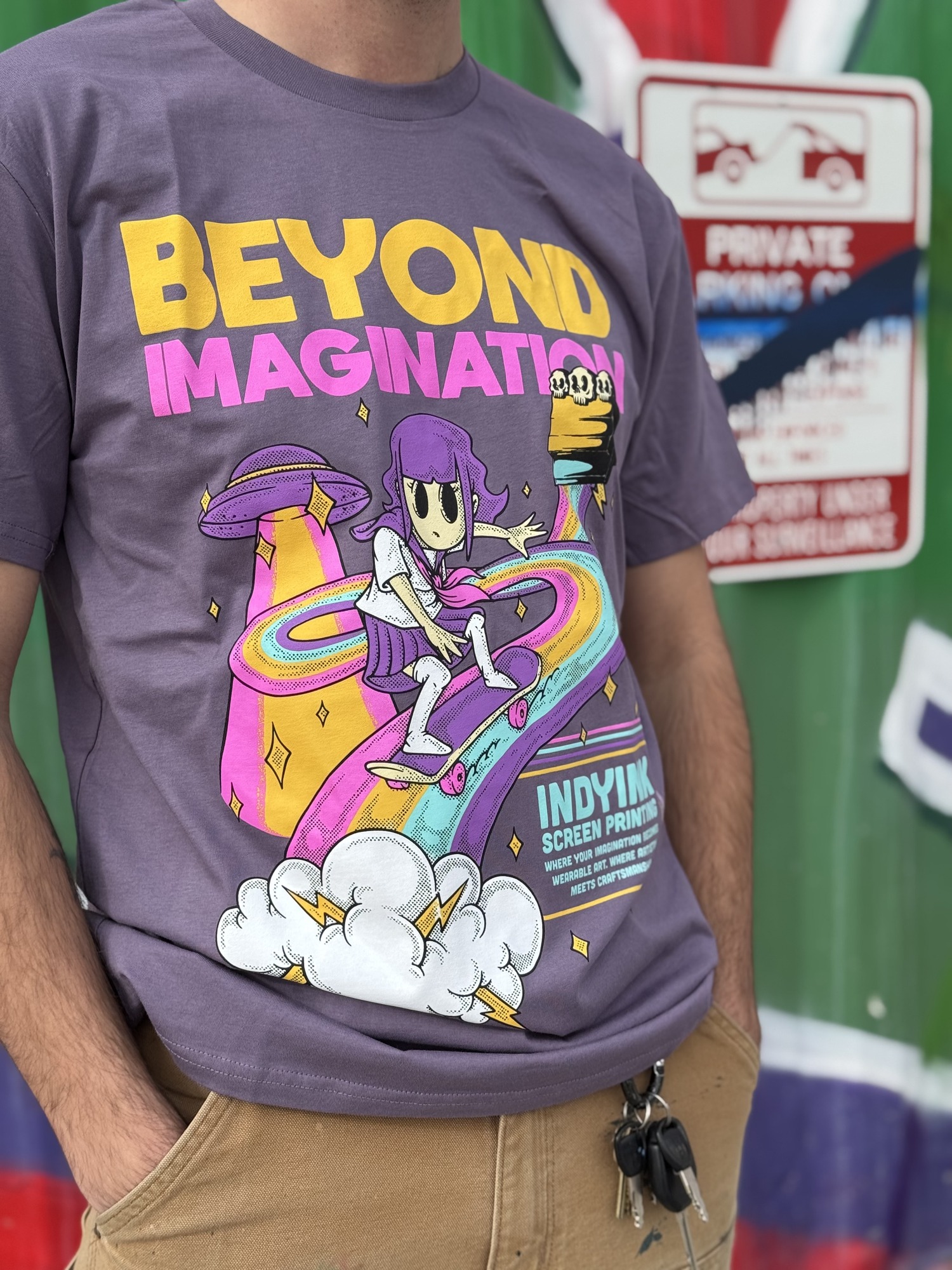 IndyInk Beyond Imagination Tee - colorful skater and UFO design on purple blank