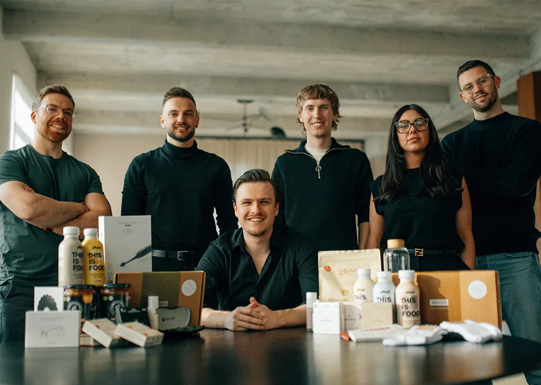 A group of people in black shirts and glasses pose for a picture.