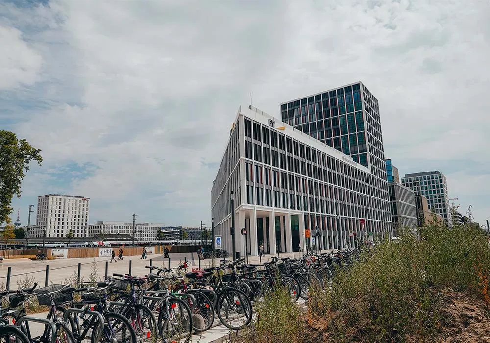 A large building with a lot of bikes in front of it.